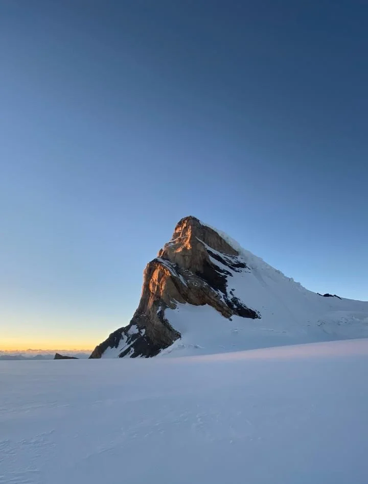 Snow-covered Mount Kun above a glacier at sunrise in Ladakh