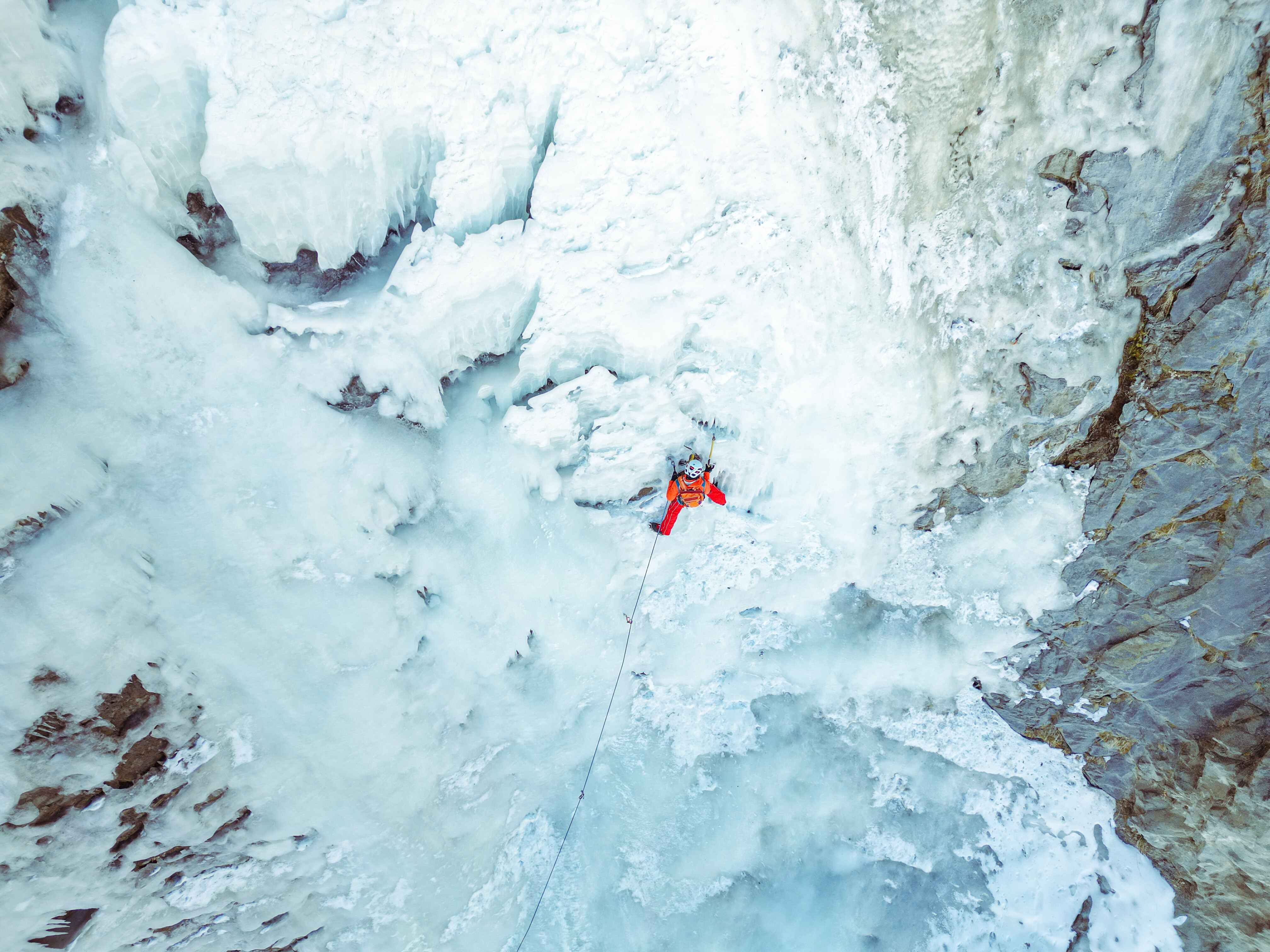 Participant ice climbing on a frozen waterfall in Spiti Valley