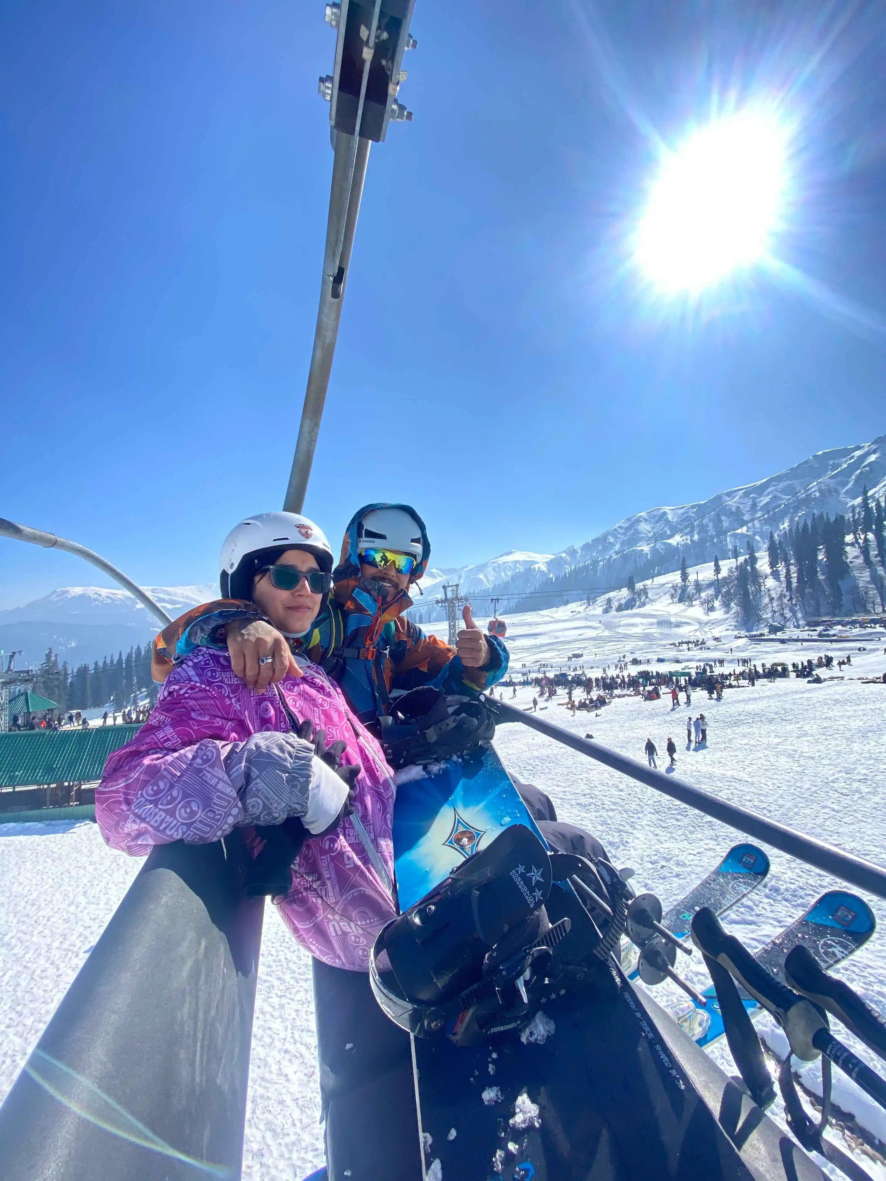 Snow-covered ski slopes at Gulmarg with skiers enjoying the winter sport