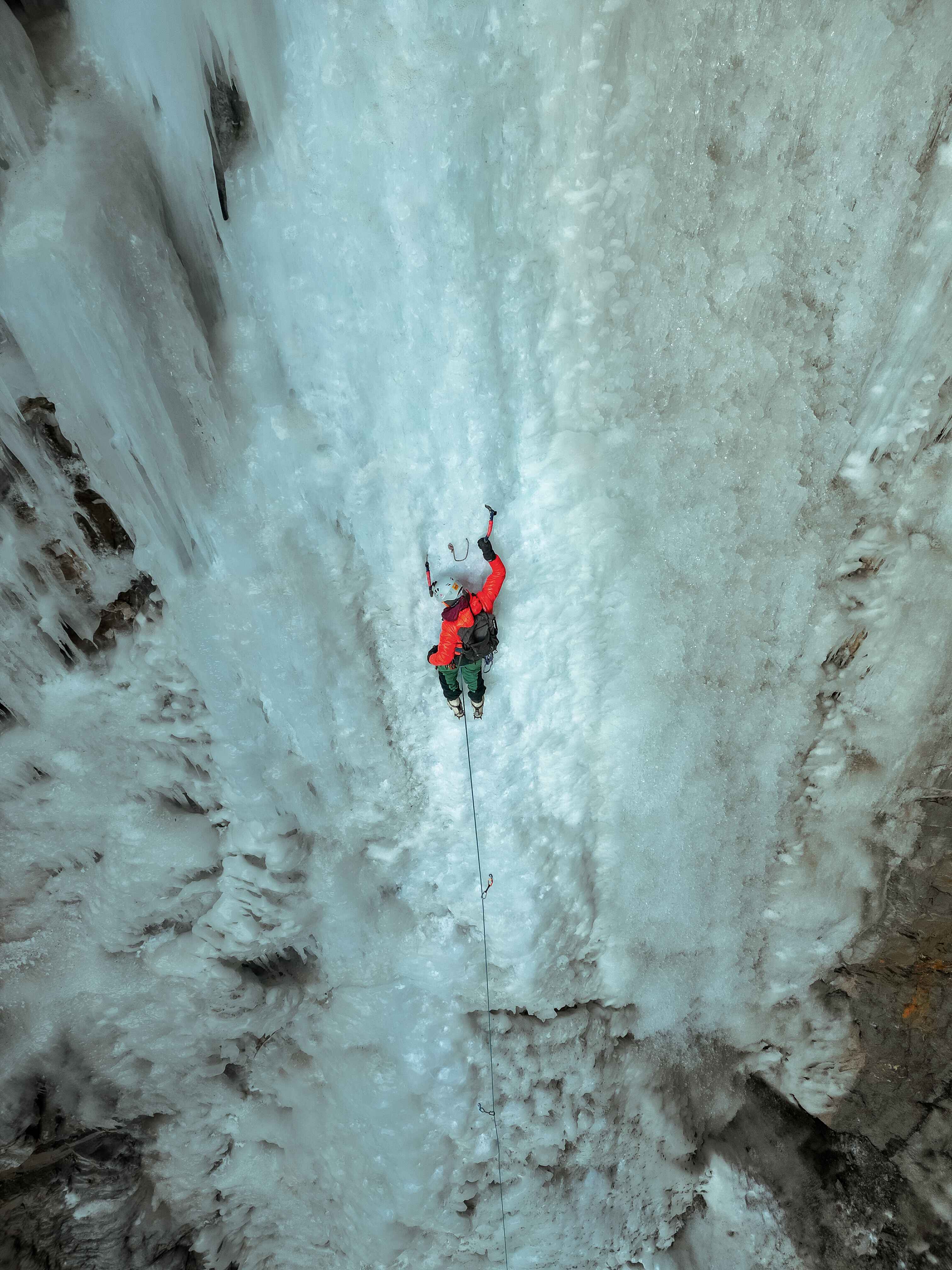 Ice climber ascending a frozen waterfall in Spiti Valley